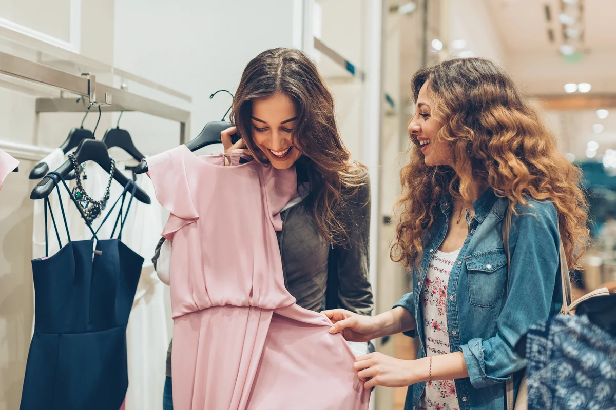 Two girls shopping for dresses