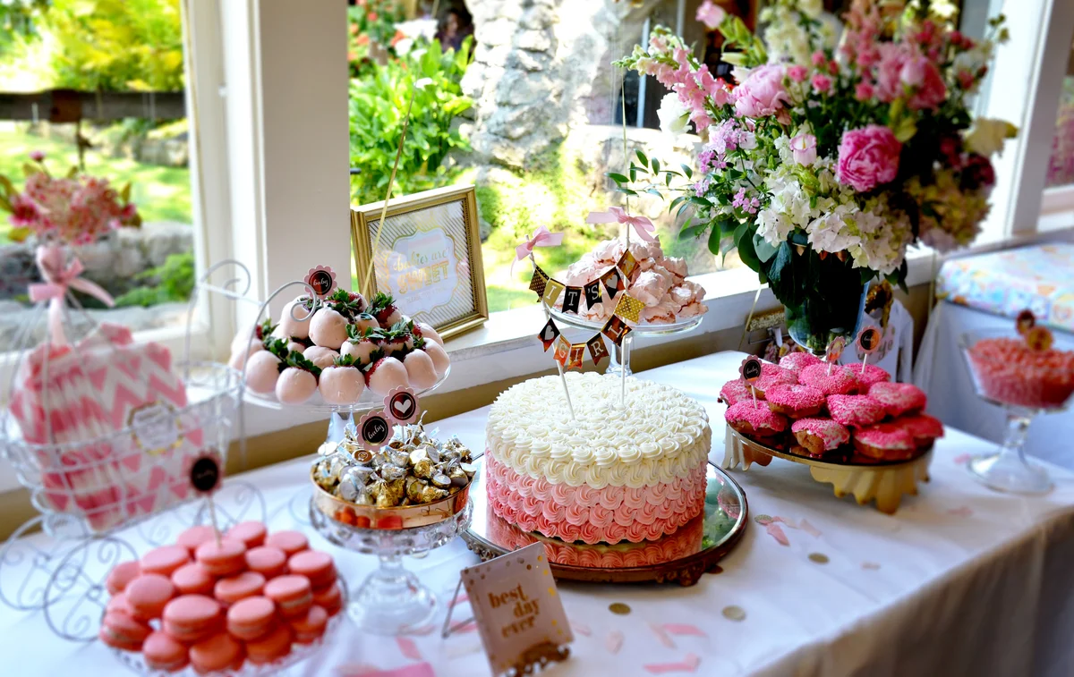 Pink baby shower dessert table with beautiful flowers