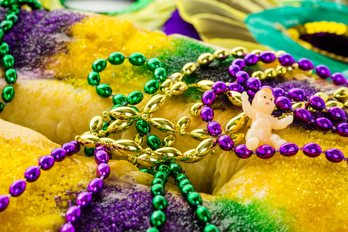 Tiny plastic baby on Mardi Gras king cake