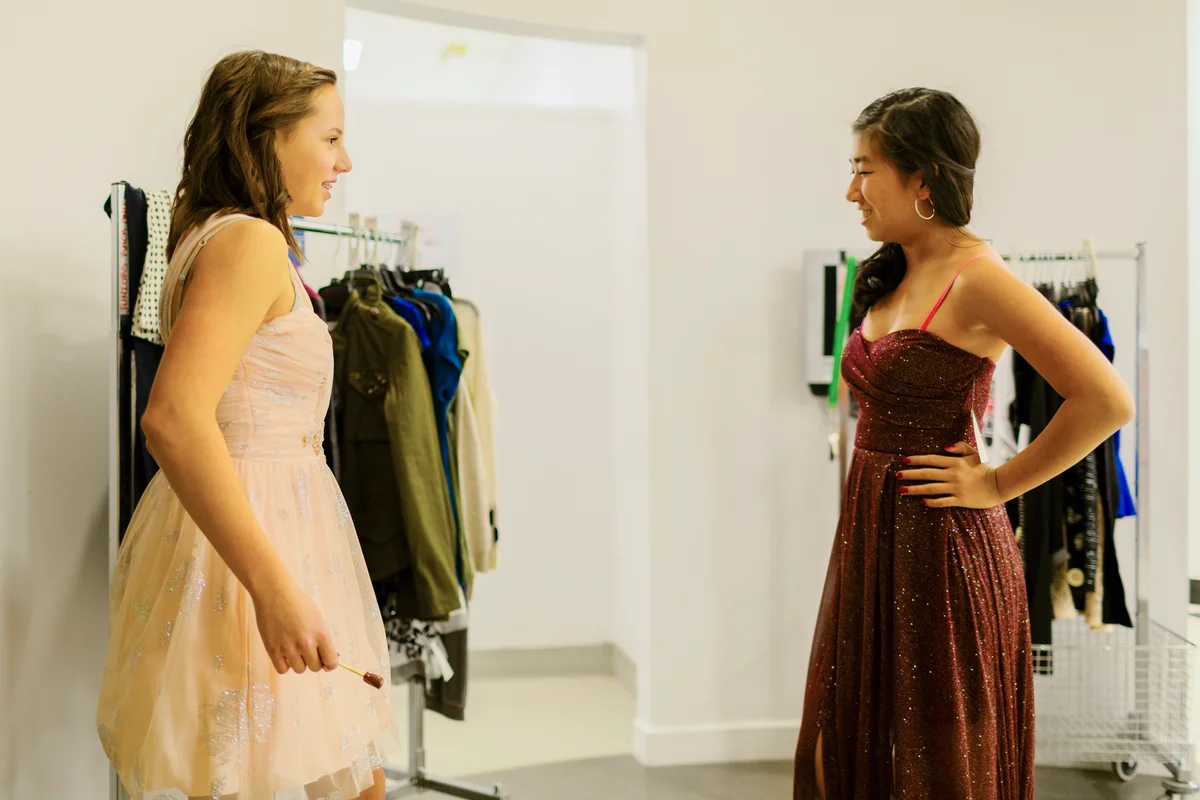 Girls trying on prom dresses
