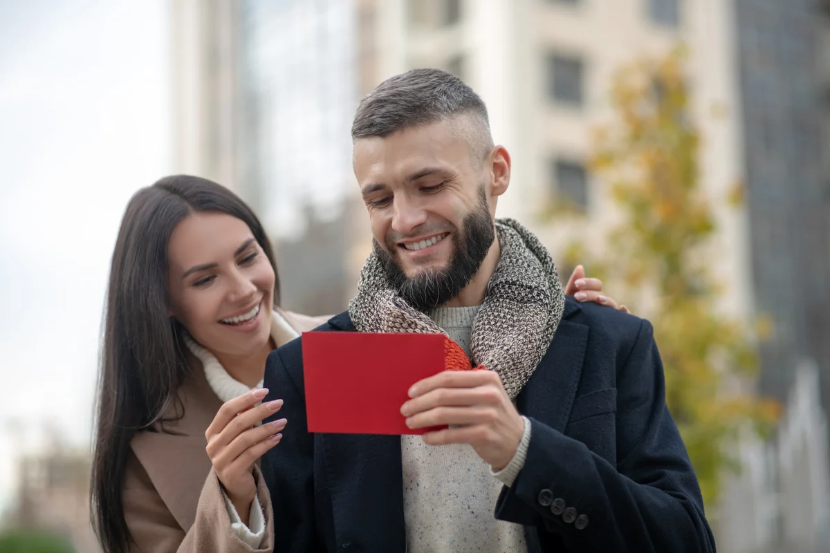 Woman giving man love letter