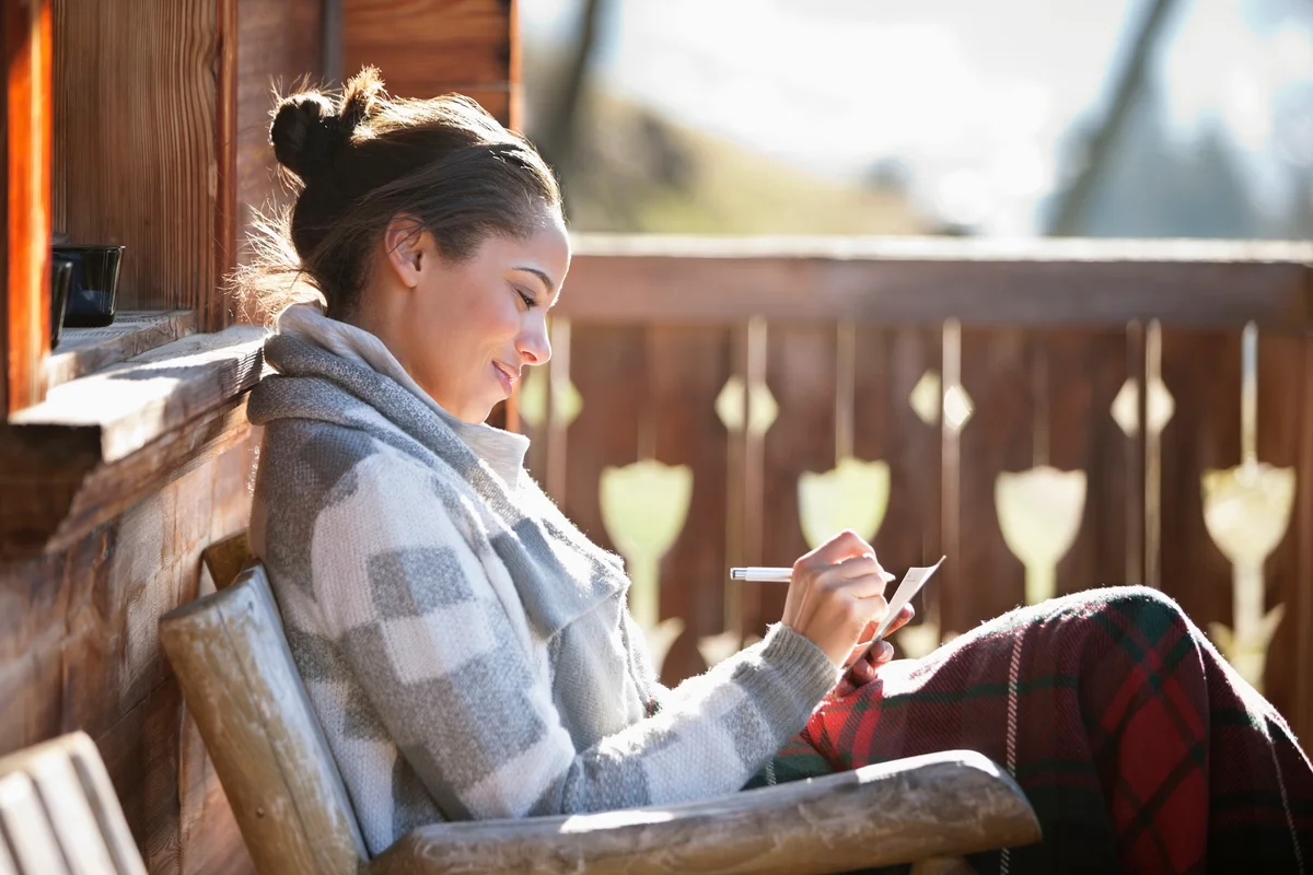 Woman sitting outside writing love letter