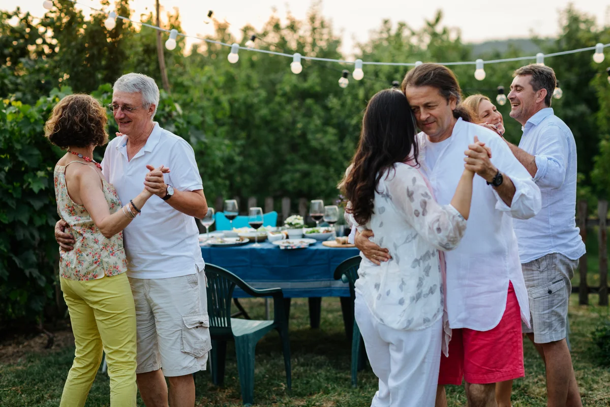 Couples dancing outdoors at a picnic