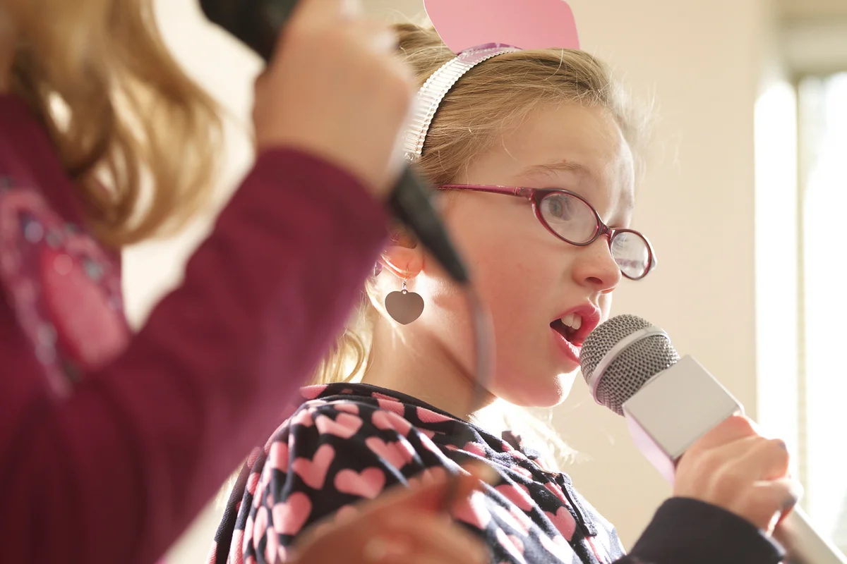 Girls doing karaoke at a birthday party