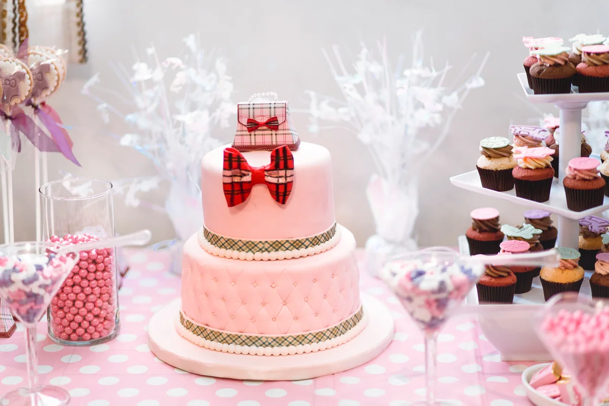 Shower cake, cup cakes and candies on a table