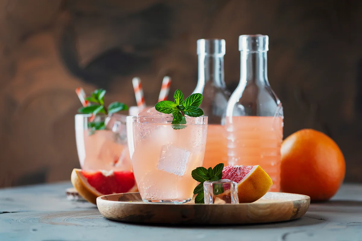 Pink cocktail with grapefruit and mint, selective focus