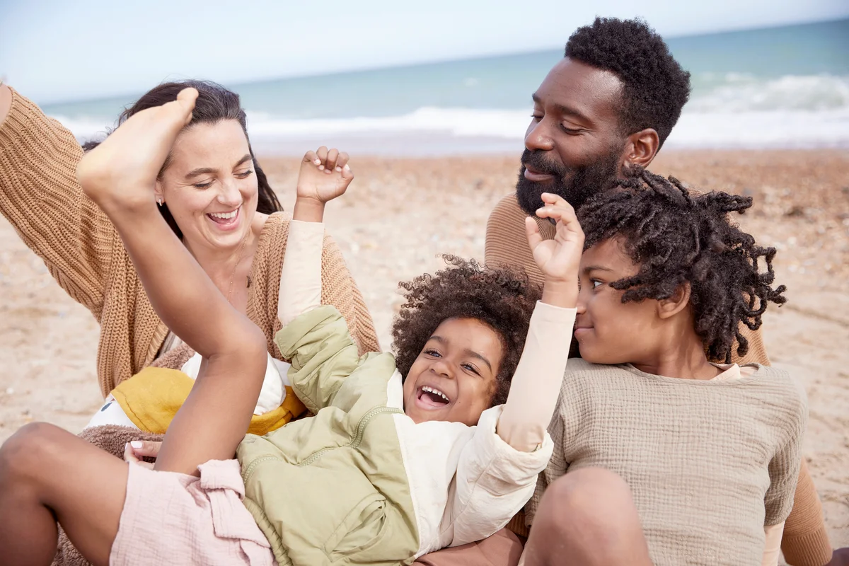Family whooping with joy at the beach