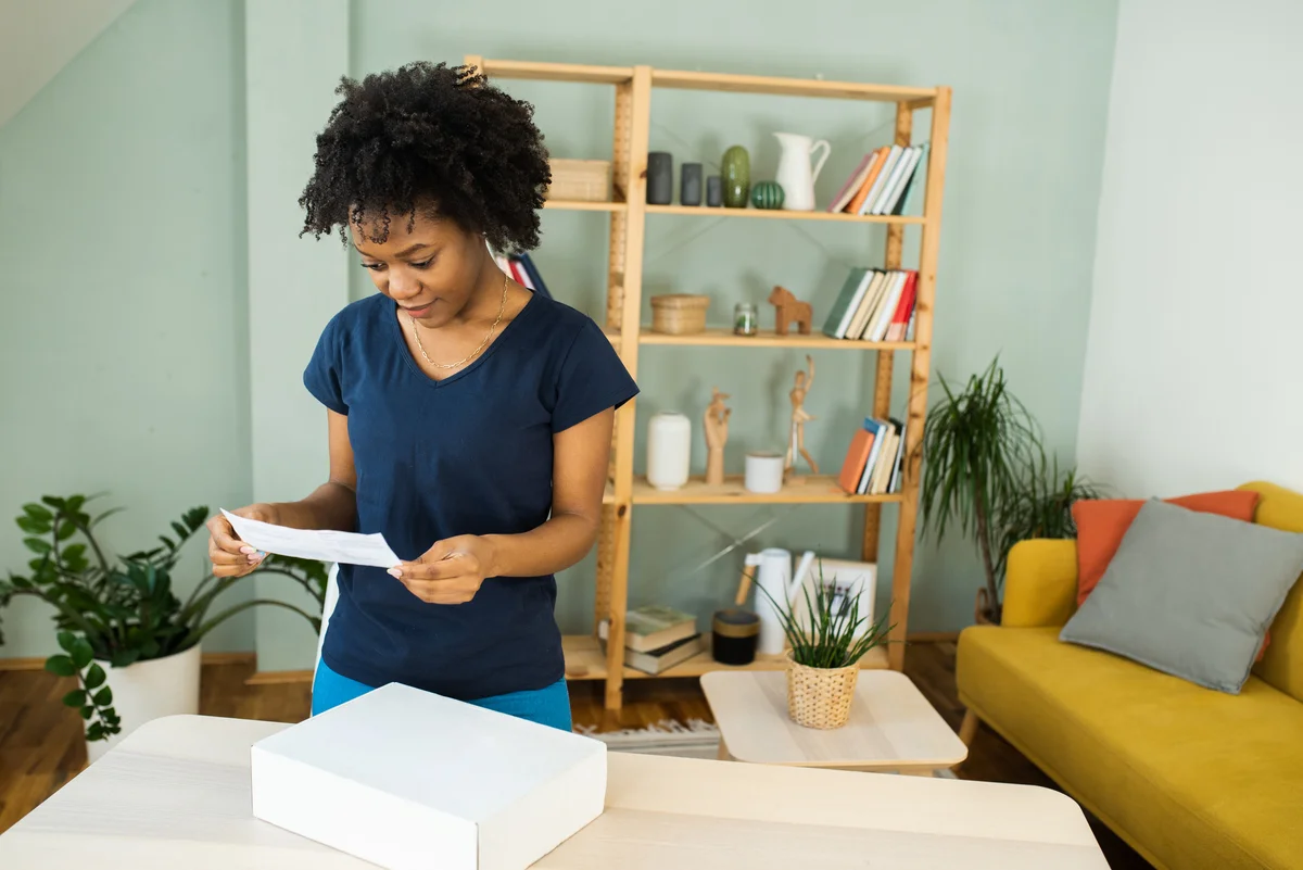 Woman reading letter with gift box
