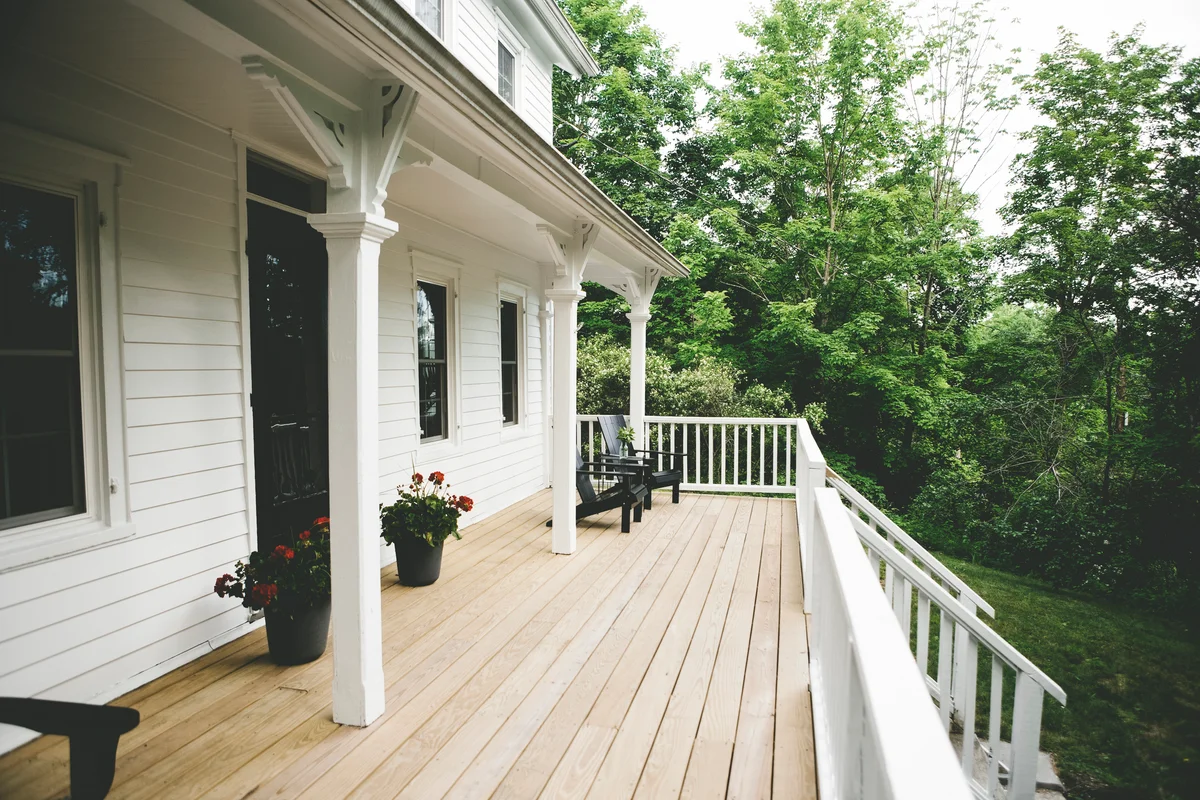 White porch with black chairs