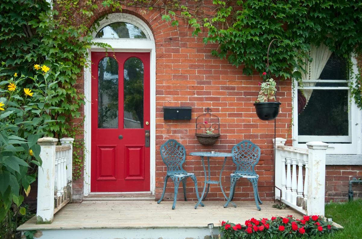 Red outside door with a patio and bistro seating
