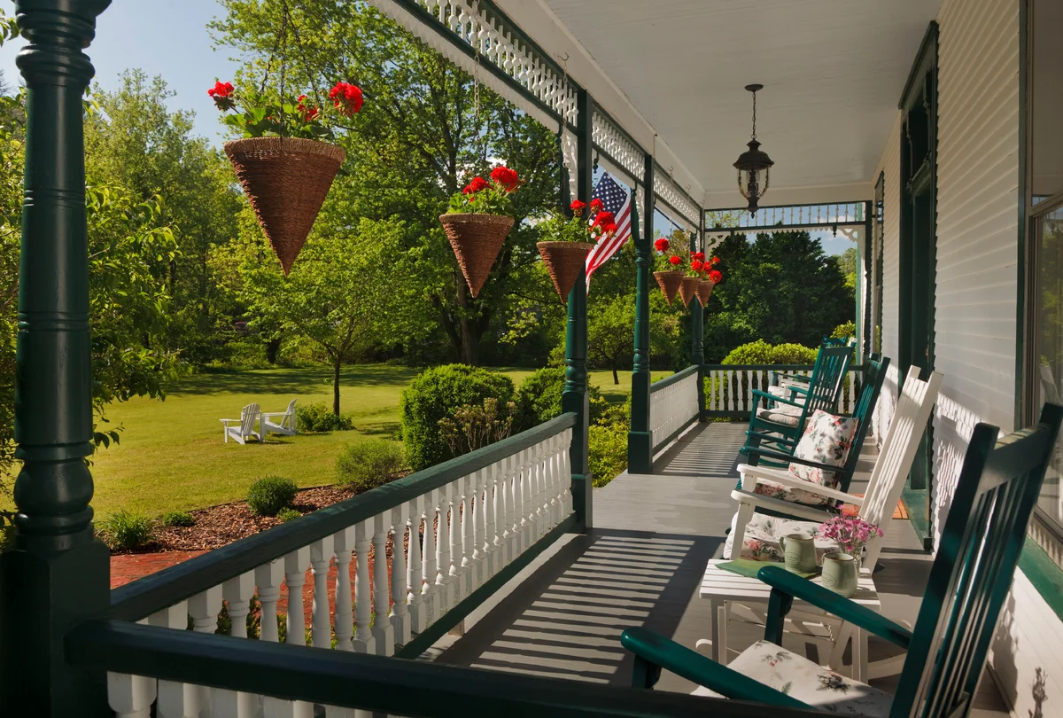 Front porch with beautiful matching hanging baskets
