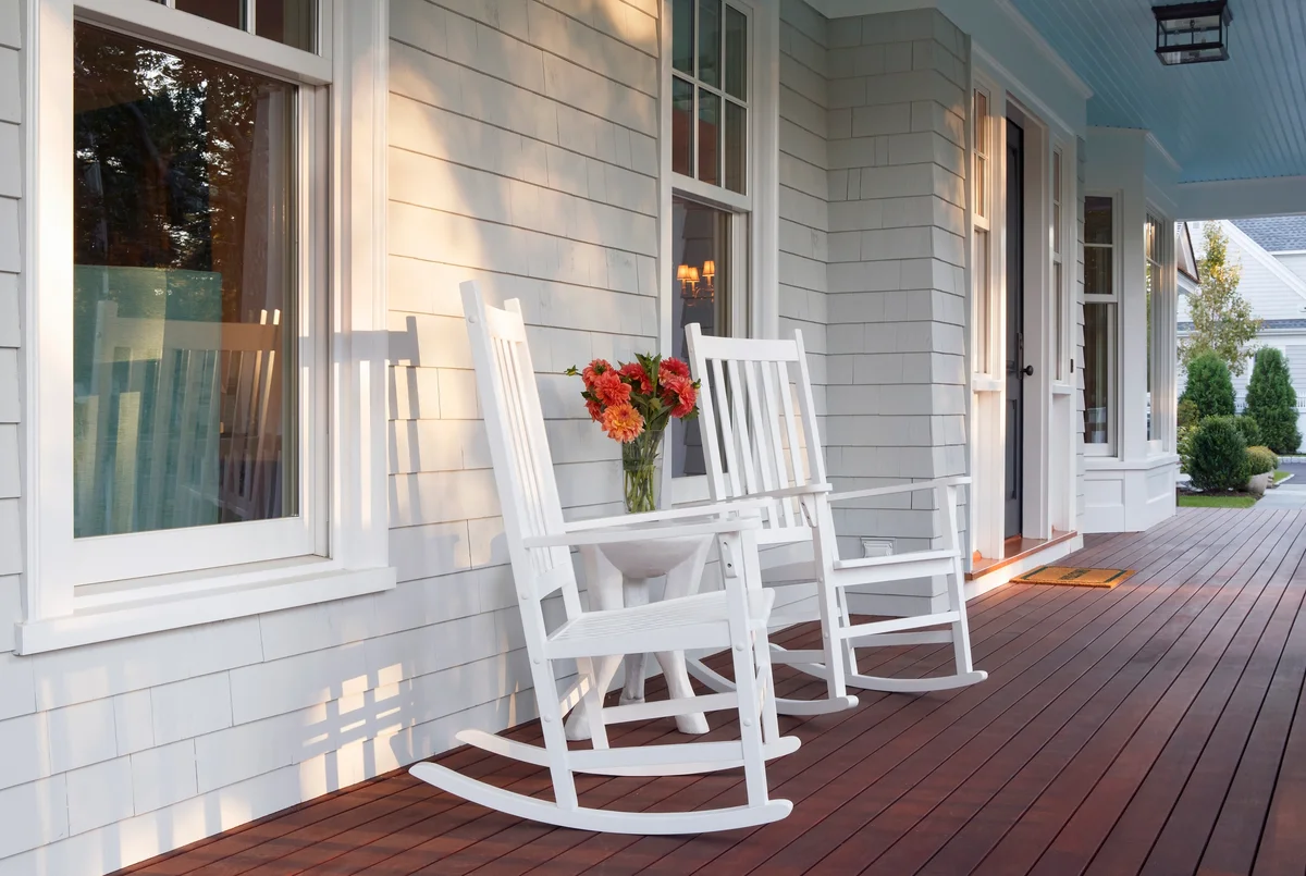 Sunlit front porch with two rocking chairs