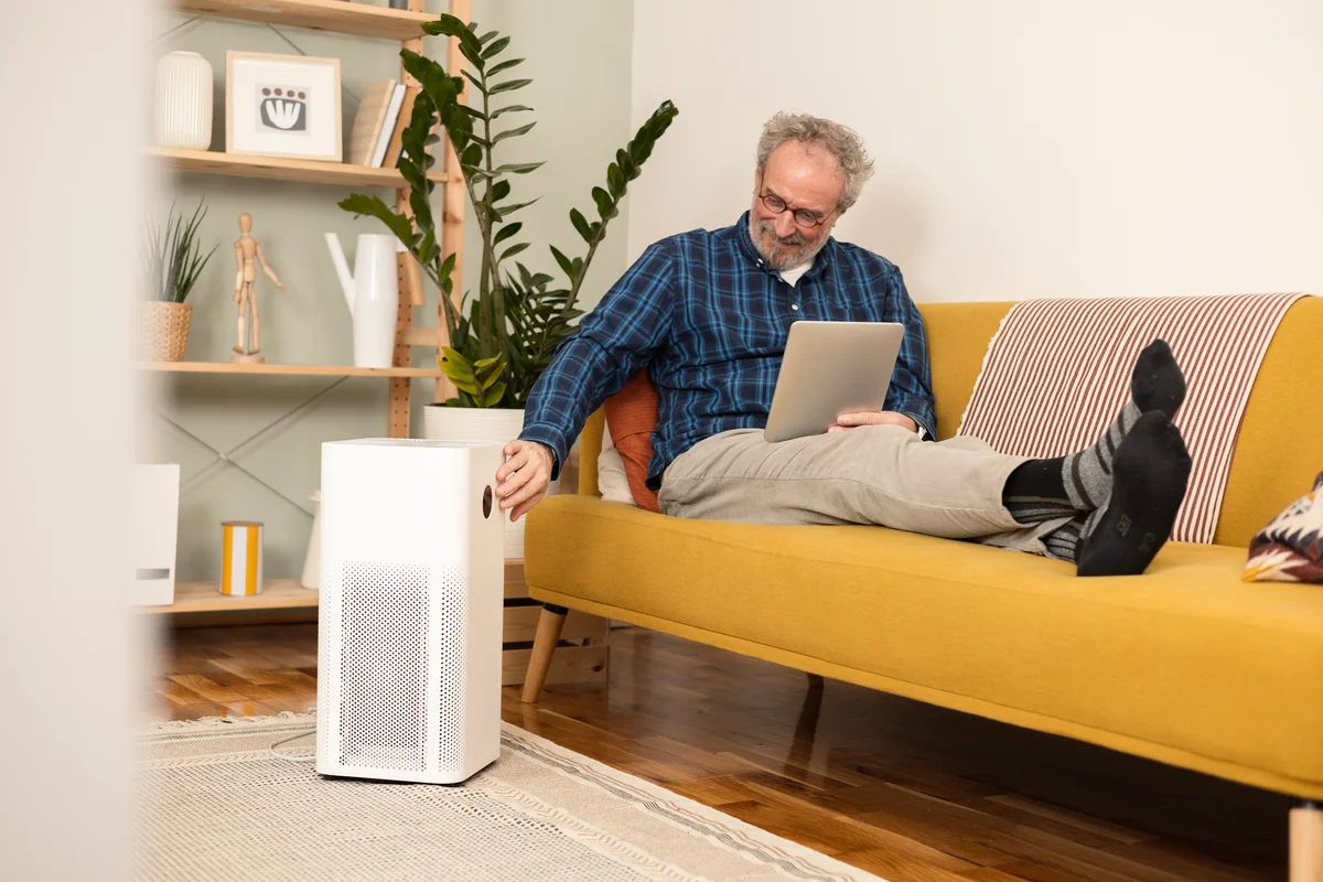 Man turning on air purifier