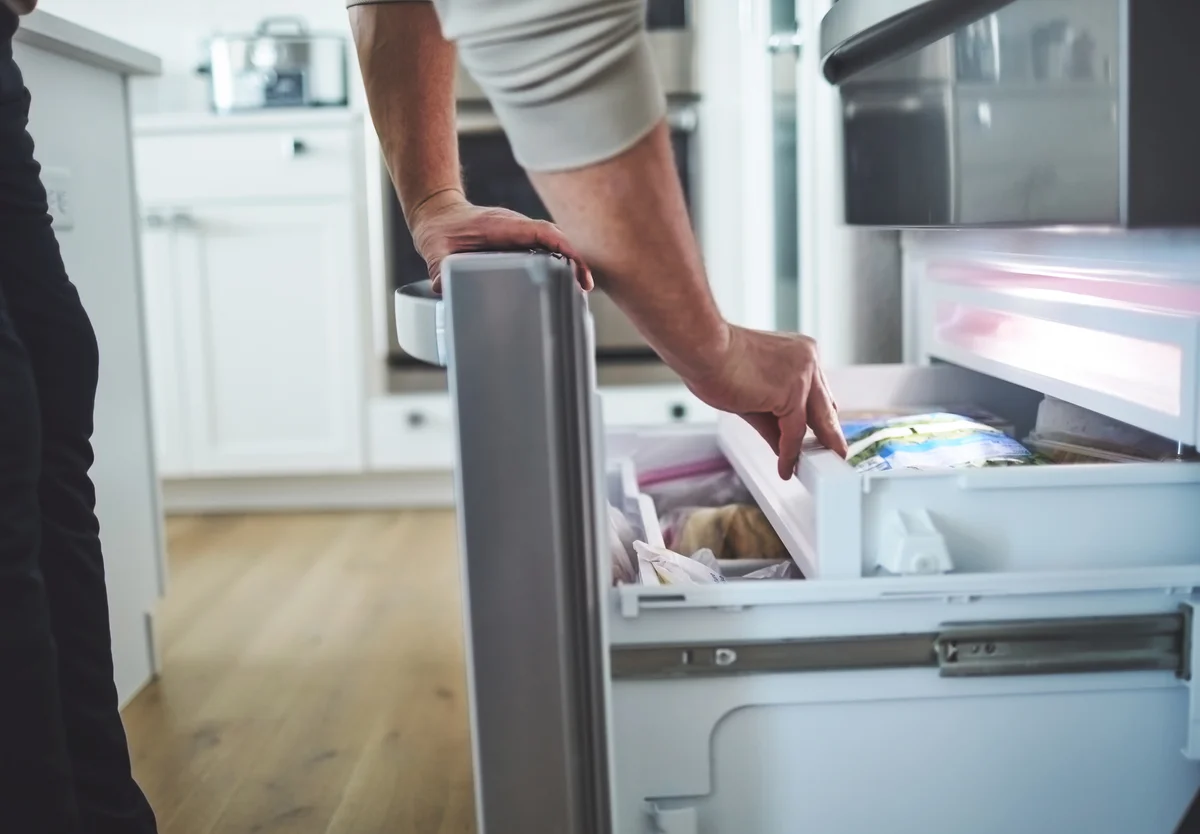 Man bending over freezer