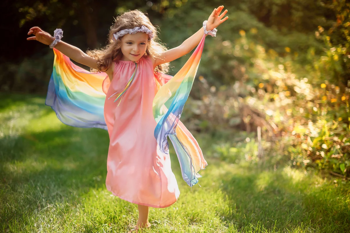 Cute Little Girl Dressed Up in a Silk Rainbow Fairy Dress
