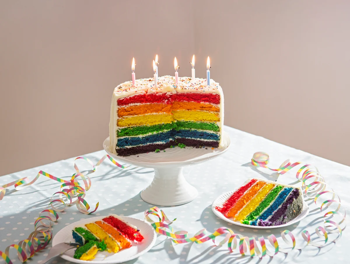 Rainbow cake on inside with white frosting on outside