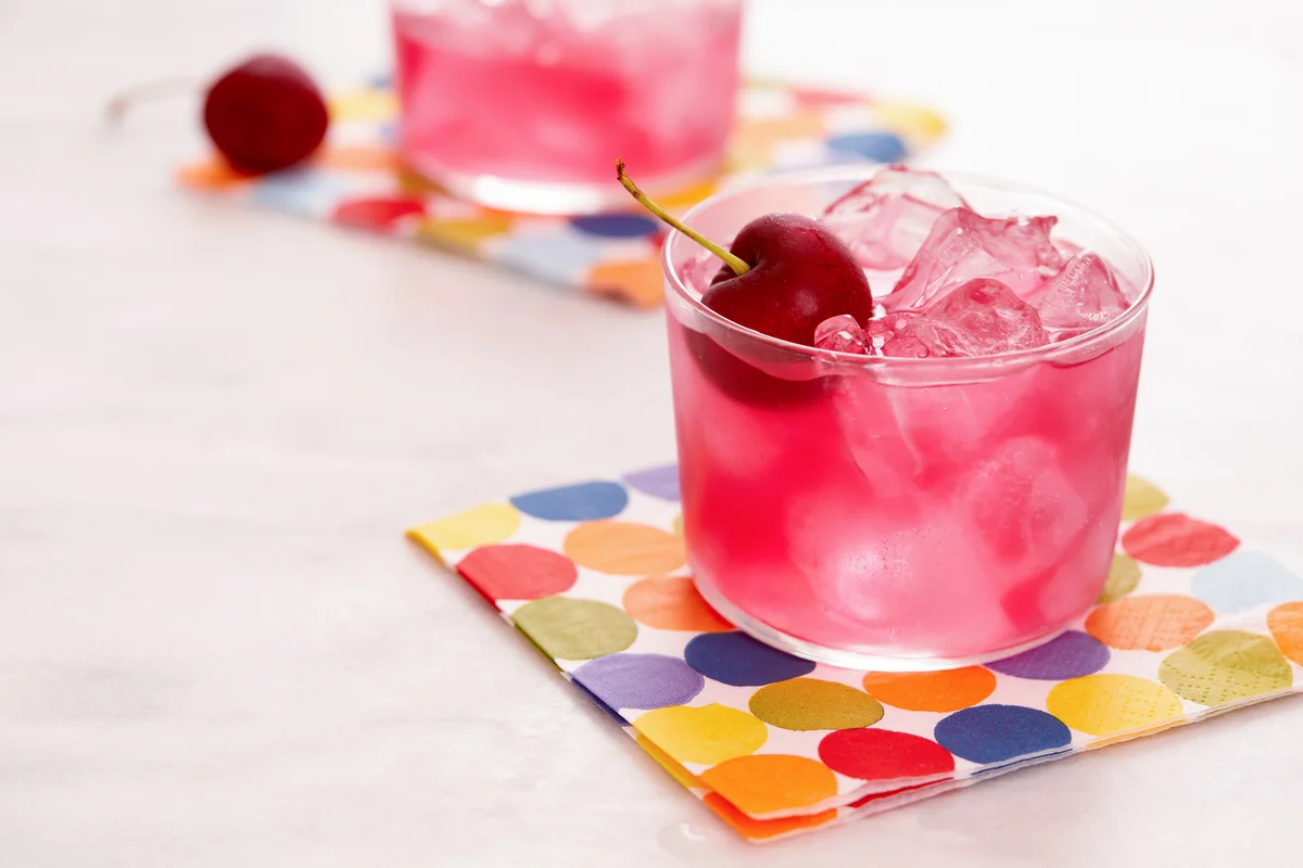 Red mocktail with cherry garnishes