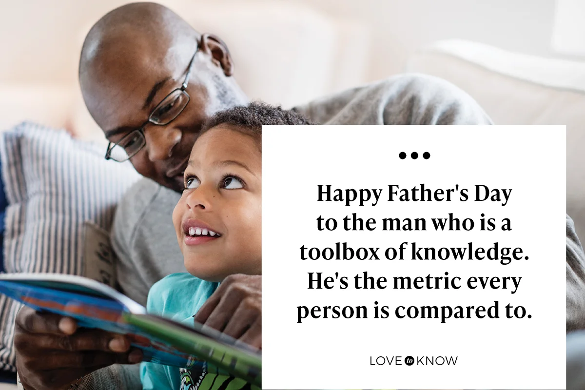 Smiling boy looking at father while reading book at home