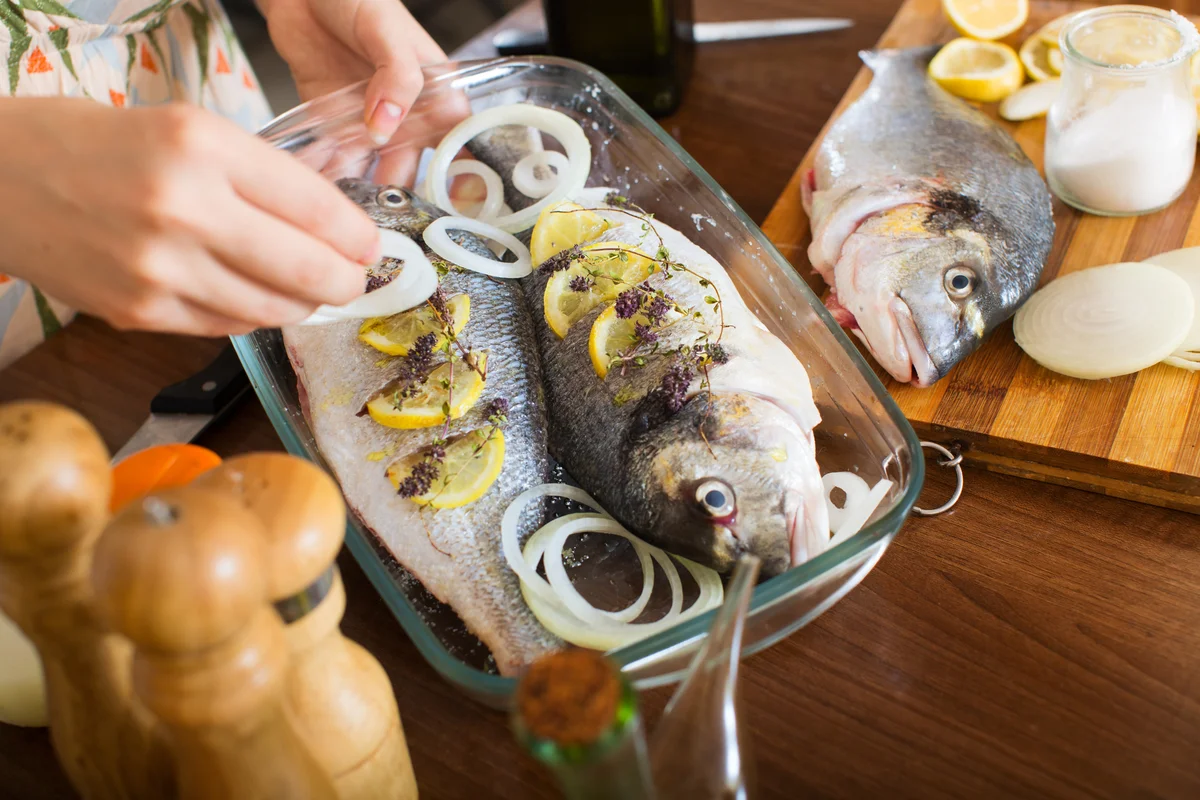woman cooking fish