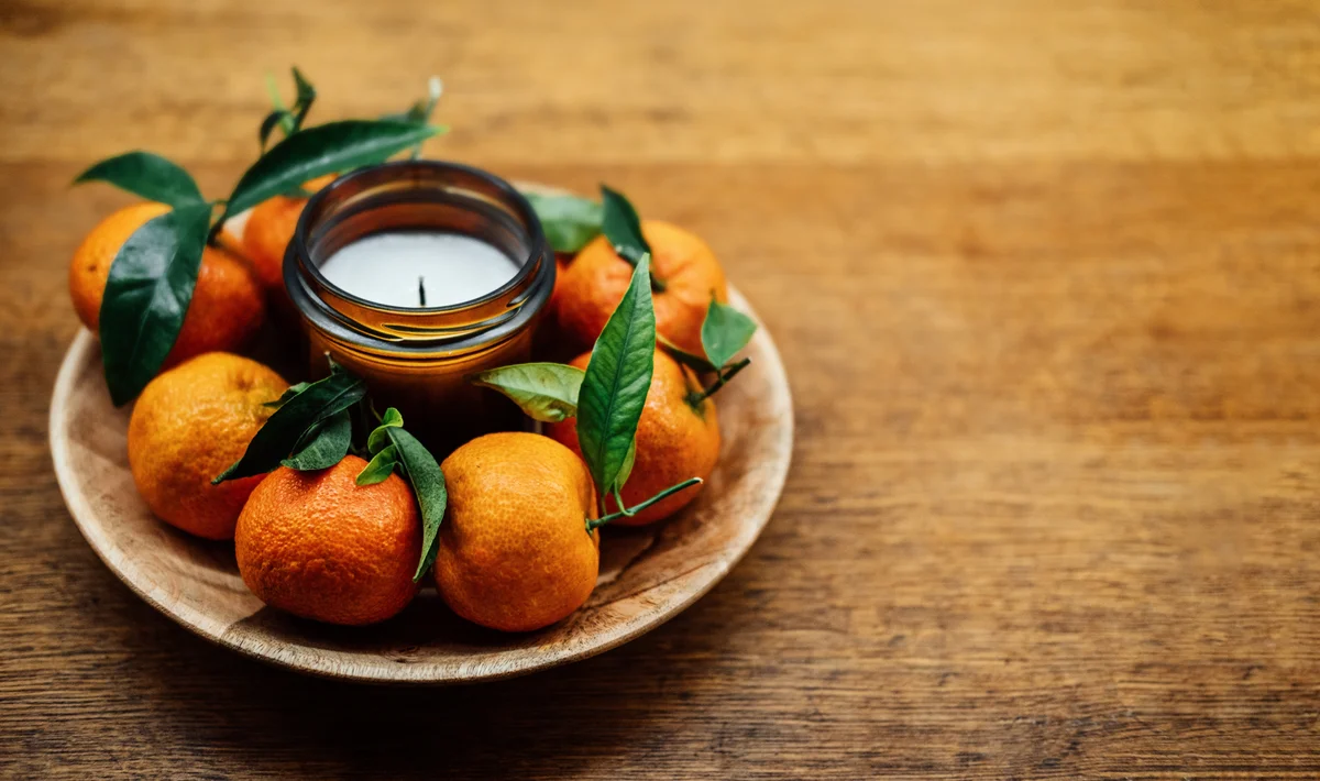 scented candle and oranges