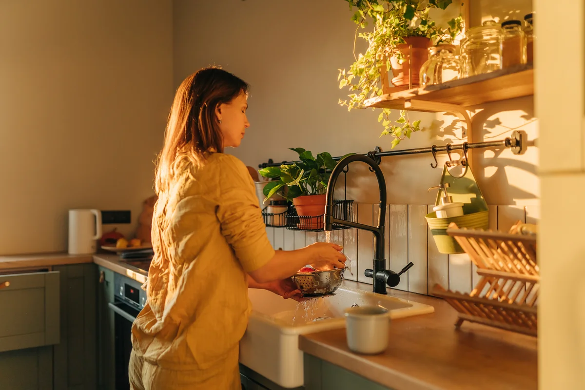 woman at sink in kitchen