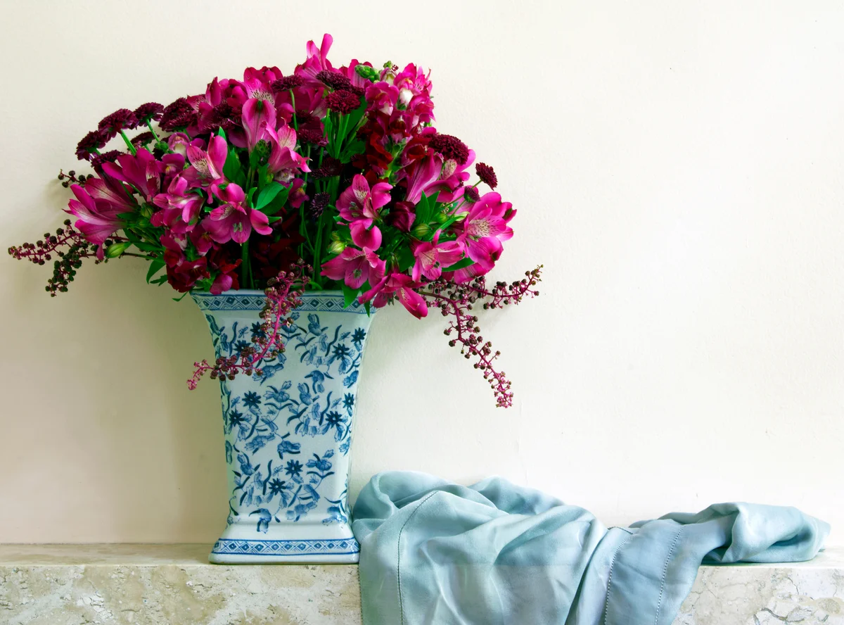 painted porcelain vase and flowers on mantel