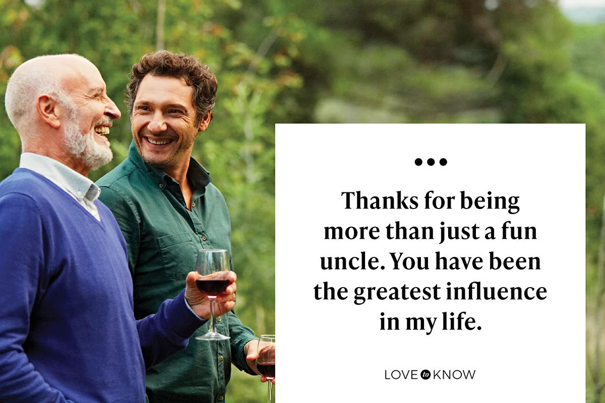 Uncle and nephew having red wine in park