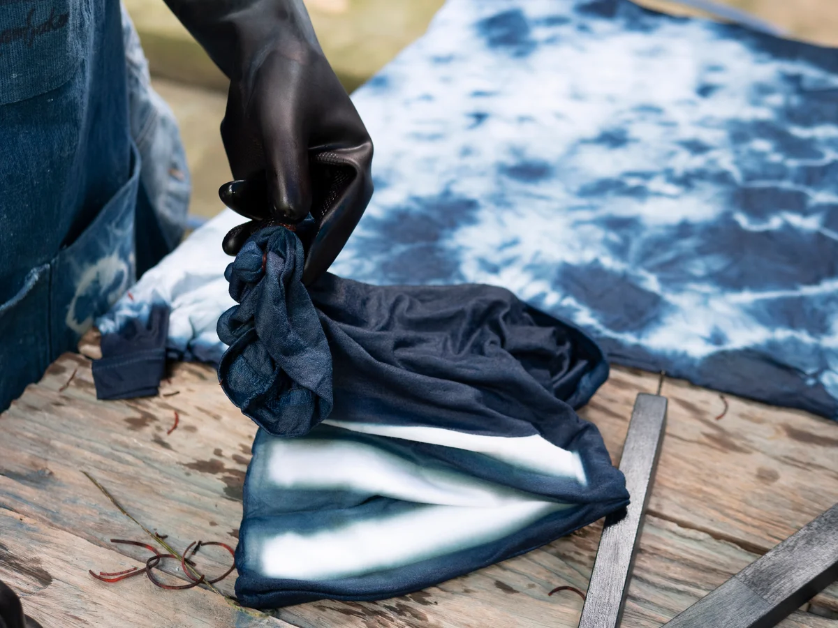 person making indigo cloth