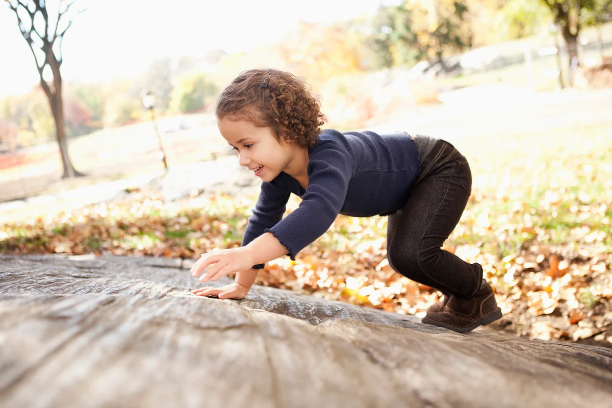 Little girl climbing on rocks