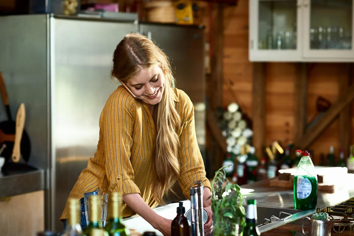 woman on phone in kitchen