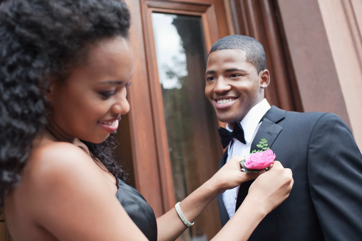 Girl adjusting her prom dates boutonniere