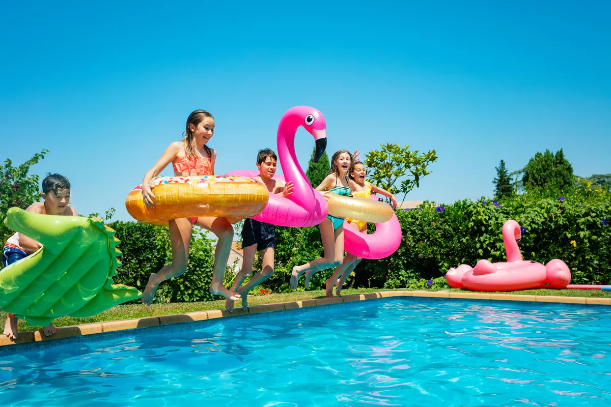 children jumping into a pool