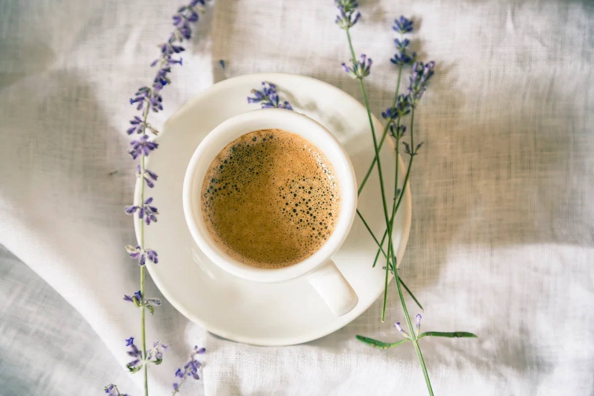 Cup of coffee with lavender on the side