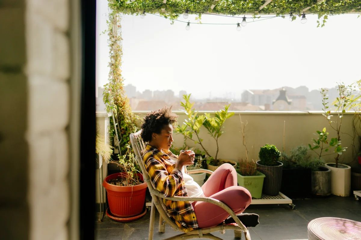 Woman enjoying coffee on her balcony on spring morning