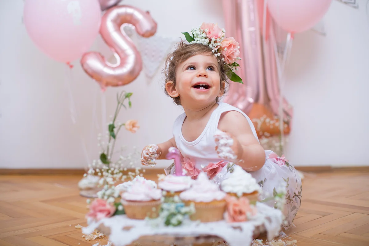 baby girl with pink cupcakes