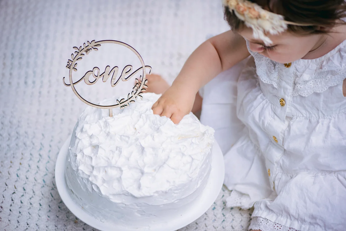 baby with white cake