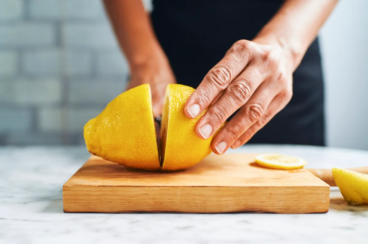 woman slicing a lemon