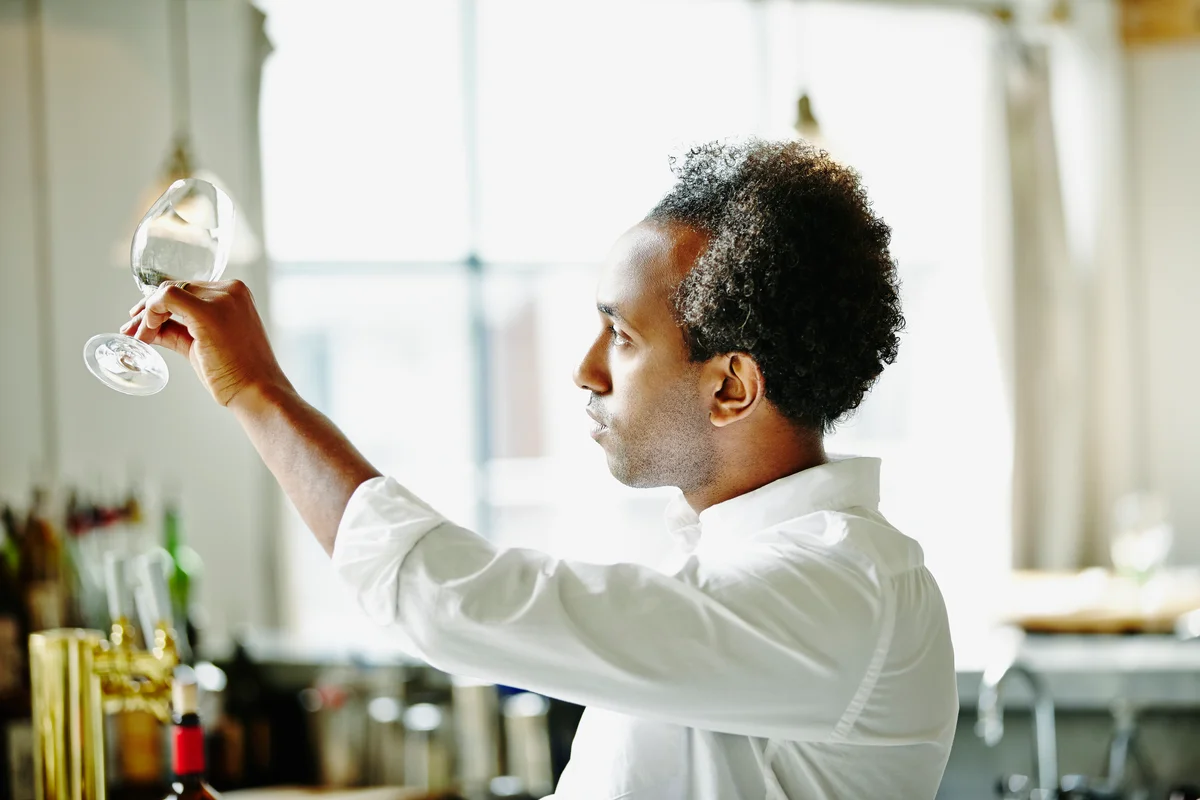 man cleaning glassware