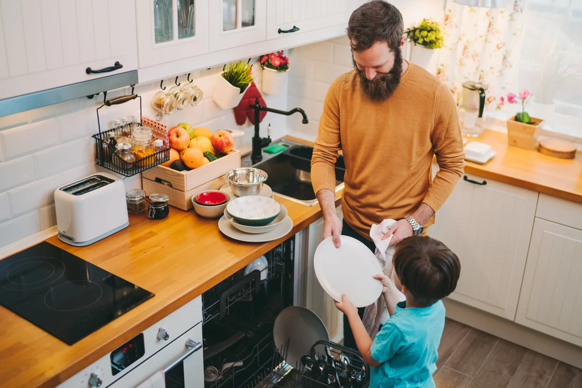 father and son doing dishes