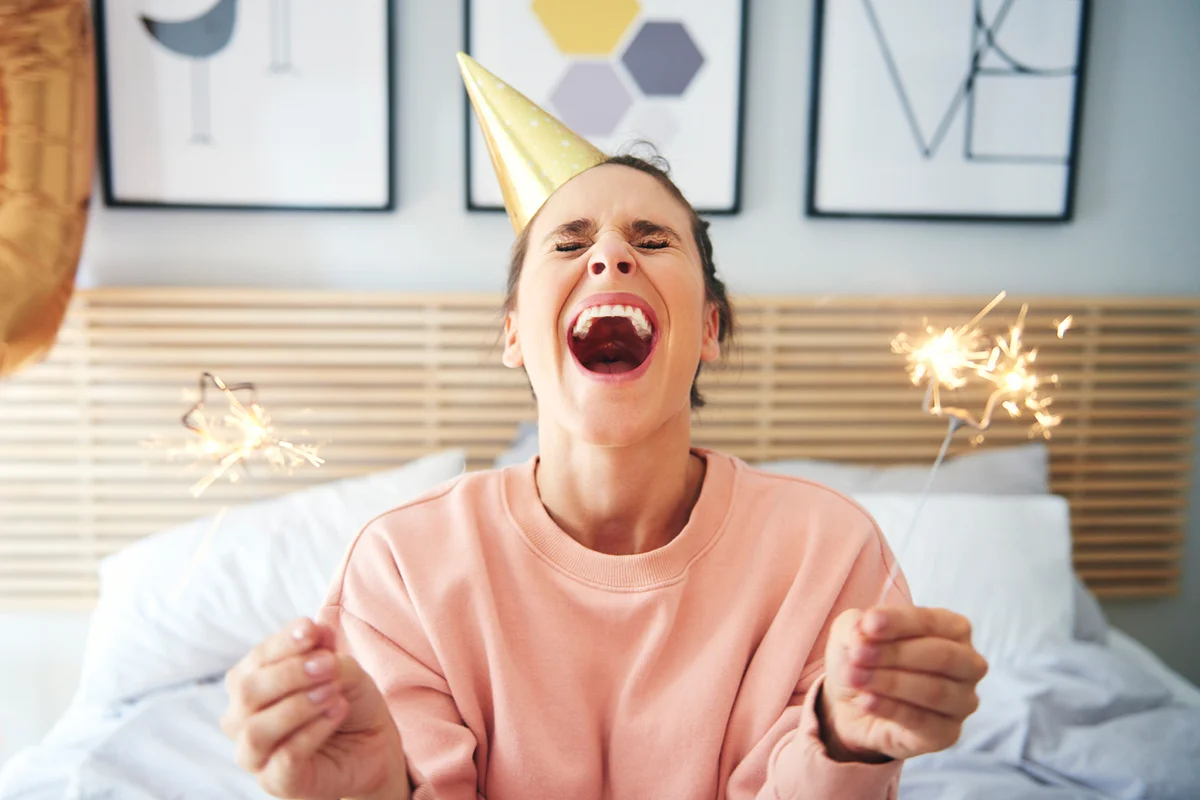 Cheerful woman during her birthday with sparklers