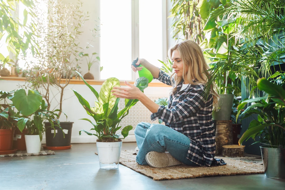 woman spraying neem oil