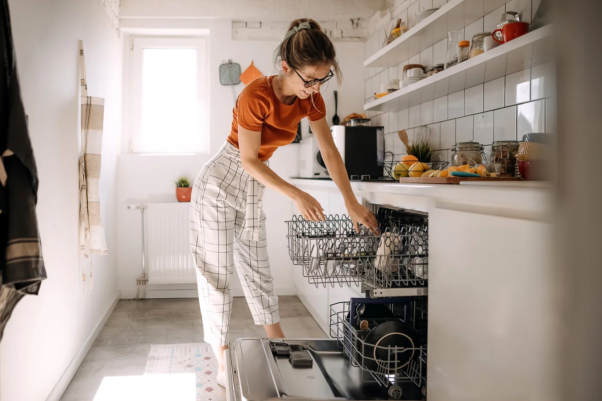 woman emptying dishwasher