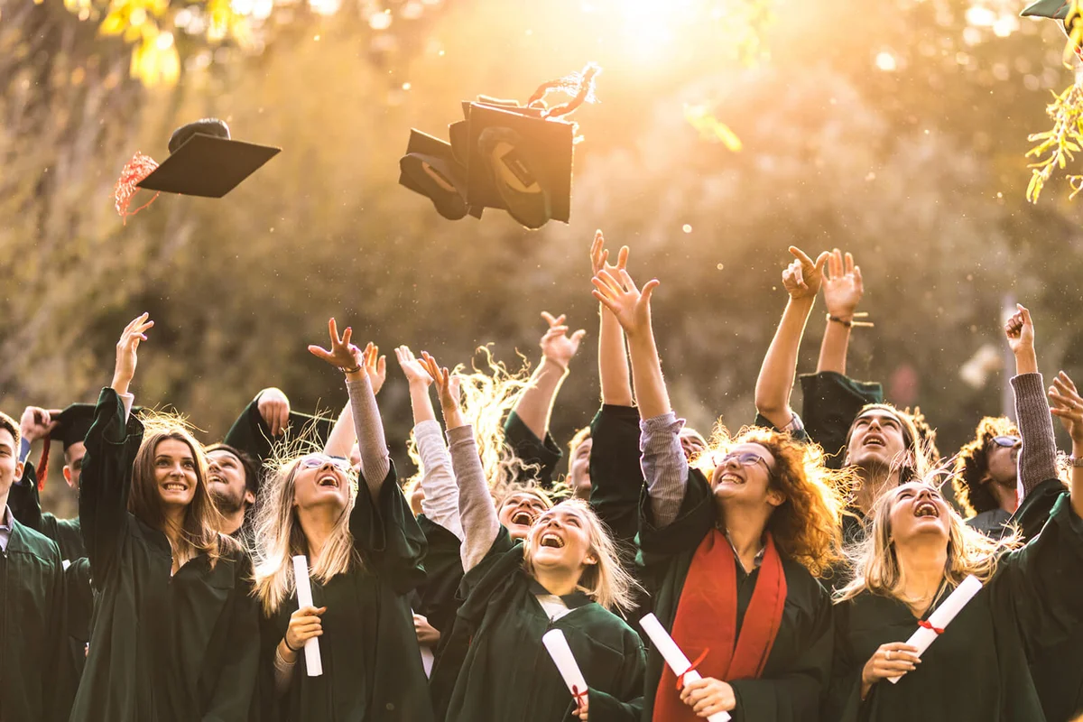 students celebrating their graduation day outdoors