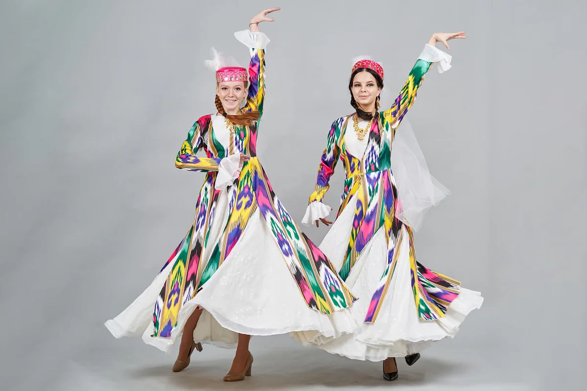 Two Cheerful Female Dancers In Uzbek National Clothes