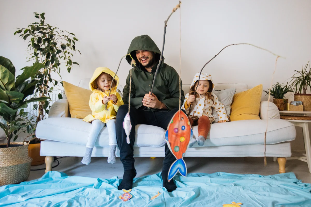 Kids & dad playing fishing at home