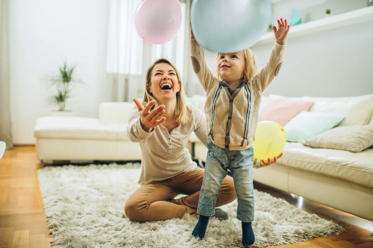 Woman & her child playing with balloons