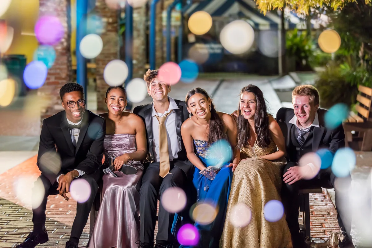 Group of friends at prom taking photo outside school
