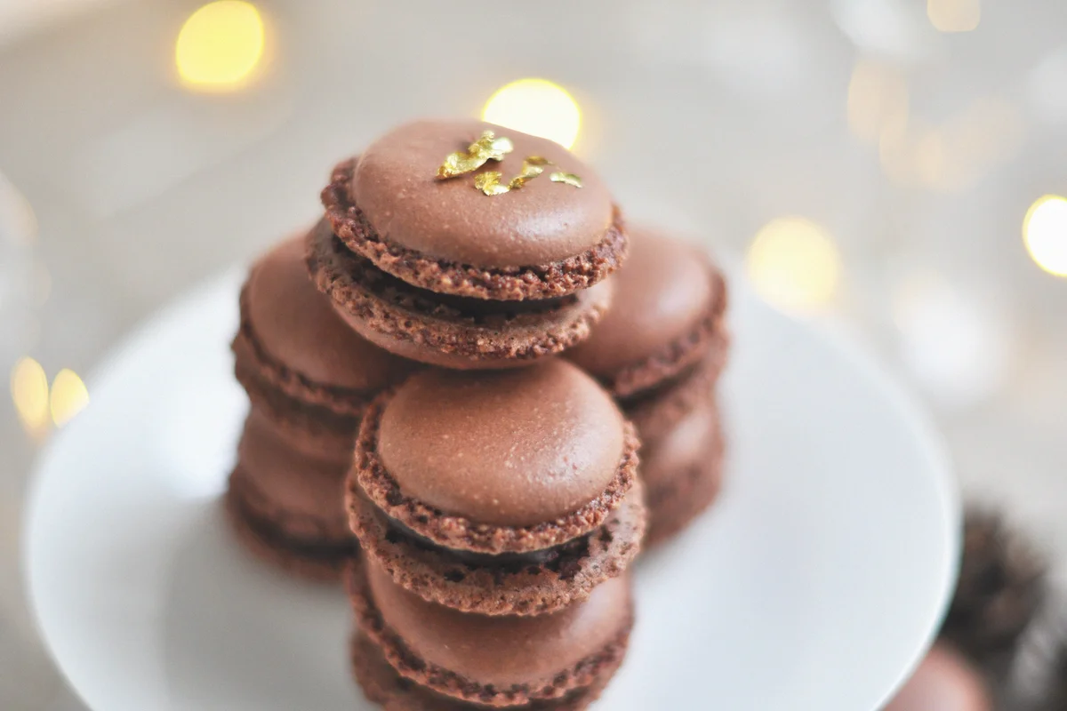 plate of chocolate macarons dusted with edible gold