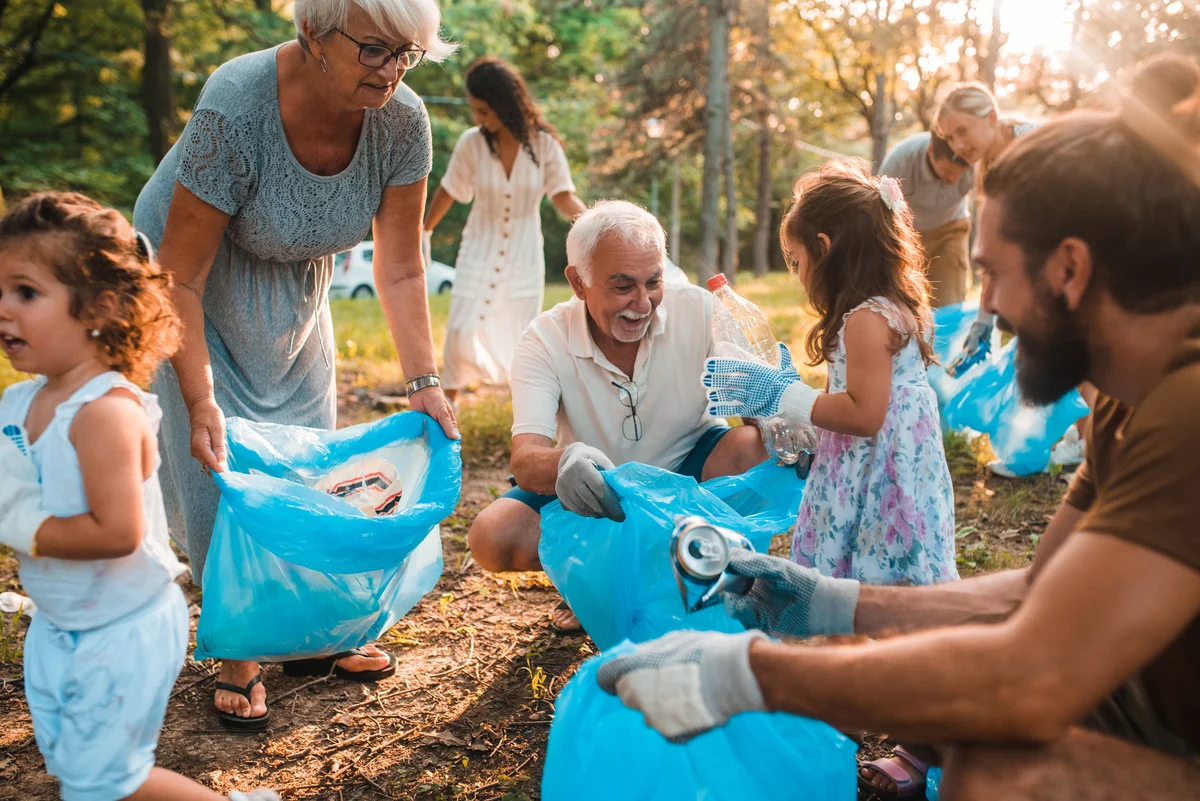 Happy multigenerational family volunteering & picking up trash