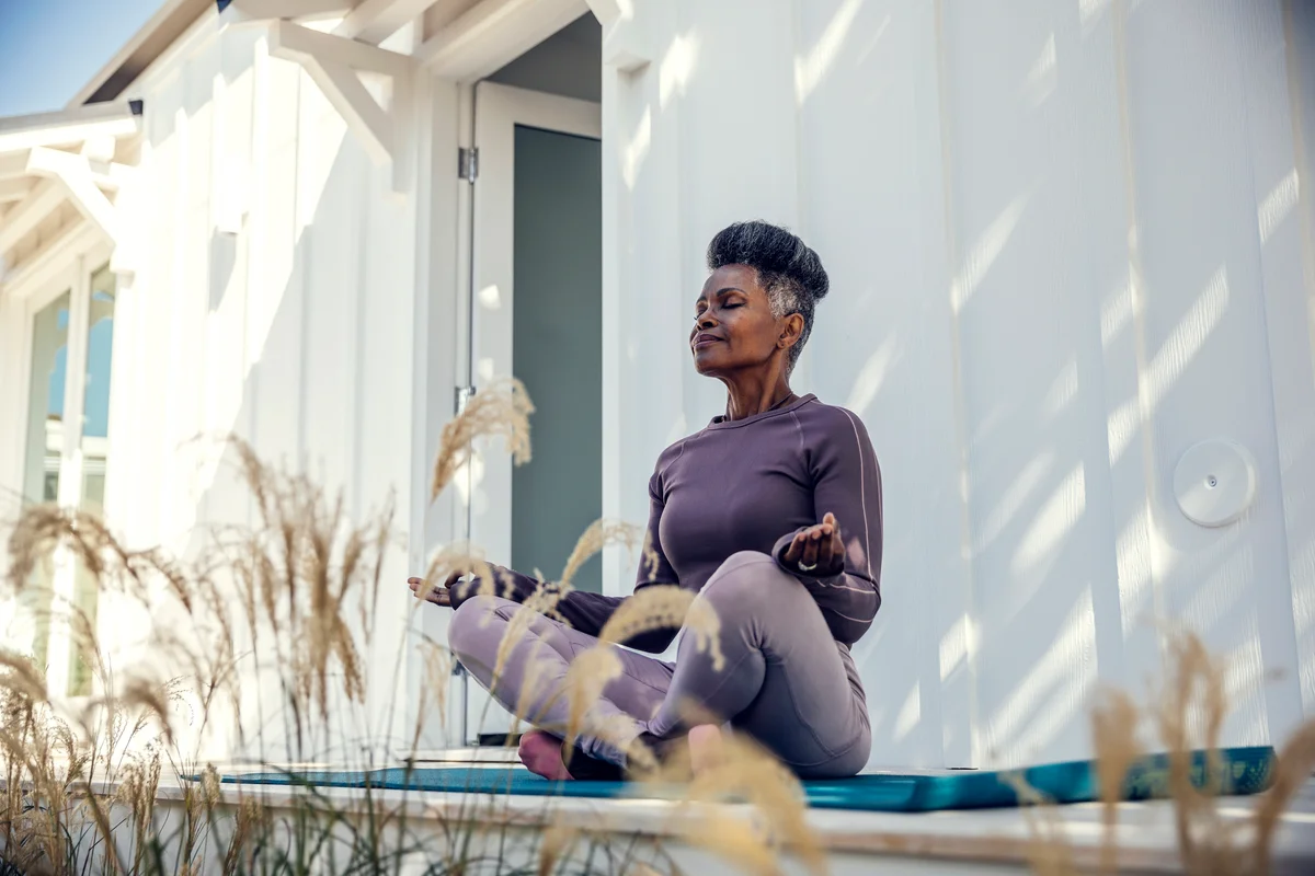woman meditating on back deck